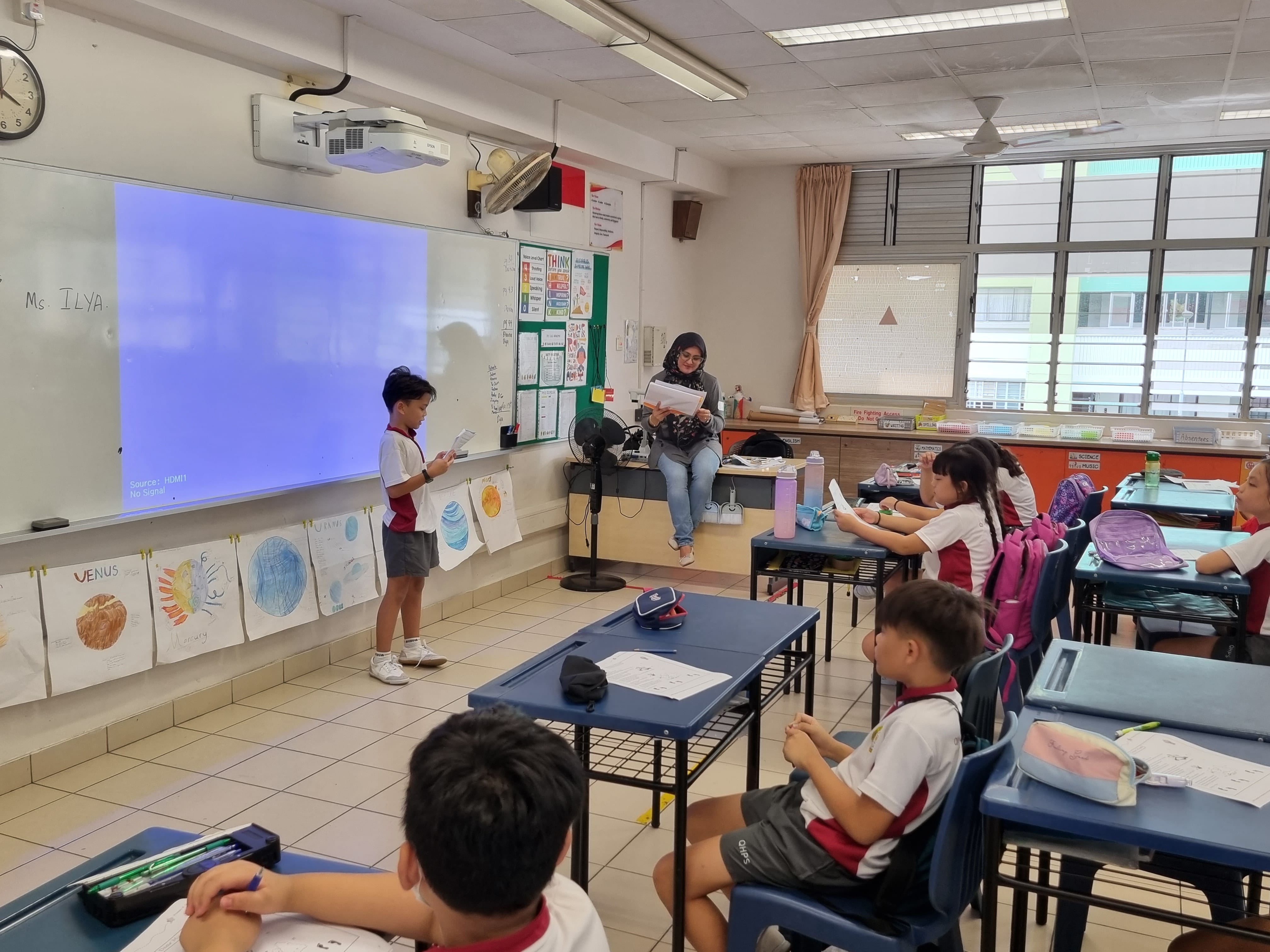 kids Excel program. Student presenting to their classmate and teacher. 